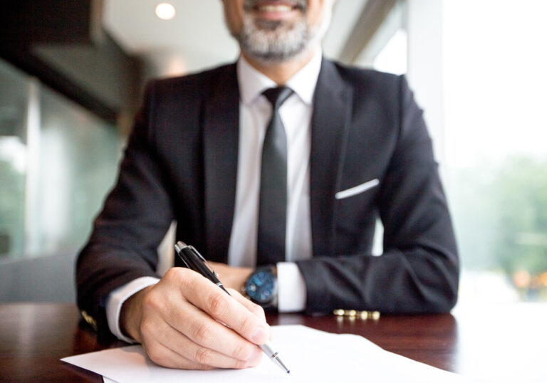 Close-up of businessman doing paperwork